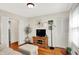 Bright living room featuring hardwood floors, a TV, and a comfortable seating area at 2512 E 57Th St, Indianapolis, IN 46220