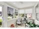 Cozy sun room with large windows, tiled floor, and bright neutral wall paneling at 2512 E 57Th St, Indianapolis, IN 46220