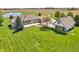 Aerial view showcasing the expansive lawn and home exterior with pond at 2575 W 100 S, Franklin, IN 46131