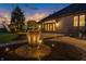 Backyard patio features accent lights, garden, and lush lawn, creating an inviting outdoor space, sunset at 2575 W 100 S, Franklin, IN 46131
