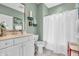 Clean bathroom with a white vanity, coordinated shelving, and a tub-shower combination with a white curtain at 2575 W 100 S, Franklin, IN 46131