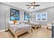 Well-lit bedroom with modern decor, light hardwood floors, and stylish ceiling fan at 2575 W 100 S, Franklin, IN 46131