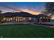 The back exterior features well-manicured landscaping and lighting highlighting sunset at 2575 W 100 S, Franklin, IN 46131