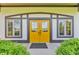 Charming front entrance with bright yellow double doors, symmetrical windows, and neatly trimmed shrubs at 2575 W 100 S, Franklin, IN 46131