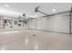 Spacious three car garage with epoxy floors, and ample tool and utility storage racks on the back wall at 2575 W 100 S, Franklin, IN 46131
