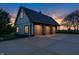 Spacious three-car garage with ample parking and an exterior that complements the sunset at 2575 W 100 S, Franklin, IN 46131