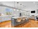 Open concept kitchen with stainless steel appliances, a large island with barstool seating, and hardwood floors at 2575 W 100 S, Franklin, IN 46131