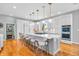 Open concept kitchen with stainless steel appliances, a large island with barstool seating, and hardwood floors at 2575 W 100 S, Franklin, IN 46131