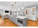 Open concept kitchen featuring an island with seating, stainless steel appliances, and a gas cooktop at 2575 W 100 S, Franklin, IN 46131