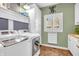 Functional laundry room featuring modern washer and dryer, storage cabinets, and a window at 2575 W 100 S, Franklin, IN 46131