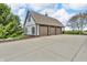 Detached building with a three-car garage, neutral exterior, and mature landscaping at 2575 W 100 S, Franklin, IN 46131