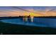 Scenic sunset view of the home overlooking a tranquil pond with a fountain at 2575 W 100 S, Franklin, IN 46131