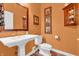 Stylish powder room featuring a pedestal sink, decorative mirror, and coordinated wall decor at 2575 W 100 S, Franklin, IN 46131