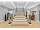 Grand staircase with light-colored carpet, wood floors, metal railings, and a skylight above at 2575 W 100 S, Franklin, IN 46131