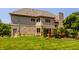 Exterior of home showing a well-manicured lawn, brick accents, and a spacious deck at 269 Manchester Ct, Noblesville, IN 46060