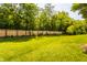 Expansive backyard featuring lush green grass, a wood privacy fence, and mature trees at 269 Manchester Ct, Noblesville, IN 46060