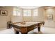 A basement is set up as a billiards room with a pool table and built-in shelving at 269 Manchester Ct, Noblesville, IN 46060