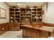 A basement office area with custom wood shelving and desk area is ready to be used at 269 Manchester Ct, Noblesville, IN 46060