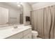 A bathroom with a white vanity, toilet, shower curtain, and a large mirror at 269 Manchester Ct, Noblesville, IN 46060