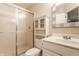 Bright bathroom with a glass-enclosed shower, white vanity and storage cabinet, and a framed mirror at 269 Manchester Ct, Noblesville, IN 46060