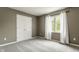 A neutral bedroom features a window and a closet with panel doors and neutral carpet at 269 Manchester Ct, Noblesville, IN 46060