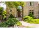 Elegant entryway featuring a brick facade, arched window, and well-manicured landscaping at 269 Manchester Ct, Noblesville, IN 46060