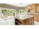 Lovely kitchen with a center island, light tile flooring, and large windows providing natural light at 269 Manchester Ct, Noblesville, IN 46060