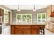 Bright kitchen featuring an island with seating, light cabinets, and sliding glass doors to the backyard at 269 Manchester Ct, Noblesville, IN 46060