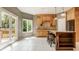 Bright kitchen with a center island, custom wood cabinets, and view to the patio at 269 Manchester Ct, Noblesville, IN 46060