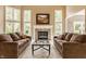 Bright living room features a fireplace, large windows, and comfortable seating at 269 Manchester Ct, Noblesville, IN 46060