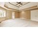 Expansive main bedroom featuring a tray ceiling, neutral carpeting, and ample natural light from the windows at 269 Manchester Ct, Noblesville, IN 46060