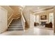 Inviting foyer with staircase leading to the living room with fireplace and large windows at 269 Manchester Ct, Noblesville, IN 46060