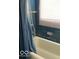 Standard bathroom with blue tiled wall and white bath tub with shower at 302 E Main St, Greenfield, IN 46140