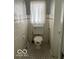 Cozy bathroom with unique flooring and tiled walls at 302 E Main St, Greenfield, IN 46140