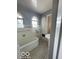 Bright bathroom with unique flooring, built-in storage, and a pedestal sink at 302 E Main St, Greenfield, IN 46140