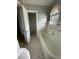Bright bathroom with unique flooring and tiled walls at 302 E Main St, Greenfield, IN 46140