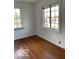 A bright bedroom with hardwood floors and natural light streaming through windows at 302 E Main St, Greenfield, IN 46140