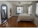 A spacious bedroom featuring hardwood floors, a built in and a comfortable full sized bed at 302 E Main St, Greenfield, IN 46140