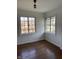 A bright bedroom with hardwood floors and natural light streaming through windows at 302 E Main St, Greenfield, IN 46140