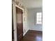 A serene bedroom featuring hardwood floors, a window, and an accent wall with whimsical wallpaper at 302 E Main St, Greenfield, IN 46140