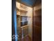 Functional closet featuring built-in storage drawers and wooden shelving at 302 E Main St, Greenfield, IN 46140