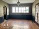 Dining room featuring hardwood floors, large window, chandelier and neutral paint at 302 E Main St, Greenfield, IN 46140