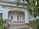 Inviting front entrance featuring a stylish archway and a sturdy concrete porch at 302 E Main St, Greenfield, IN 46140