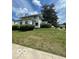 Traditional home featuring a lush green lawn and mature landscaping at 302 E Main St, Greenfield, IN 46140