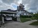 Classic white house featuring a convenient carport and lush green lawn at 302 E Main St, Greenfield, IN 46140