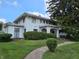Attractive two-story home with a landscaped yard and a welcoming front porch at 302 E Main St, Greenfield, IN 46140