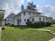 Charming two-story home with a well-maintained lawn and mature trees at 302 E Main St, Greenfield, IN 46140