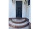 Charming front entrance with decorative brick steps and a textured stucco exterior at 302 E Main St, Greenfield, IN 46140