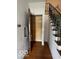 Hallway featuring a small storage closet and a staircase with a rope railing and wrought iron banister at 302 E Main St, Greenfield, IN 46140