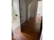 View of bathroom and hallway with hardwood flooring, neutral paint and tiled floor at 302 E Main St, Greenfield, IN 46140